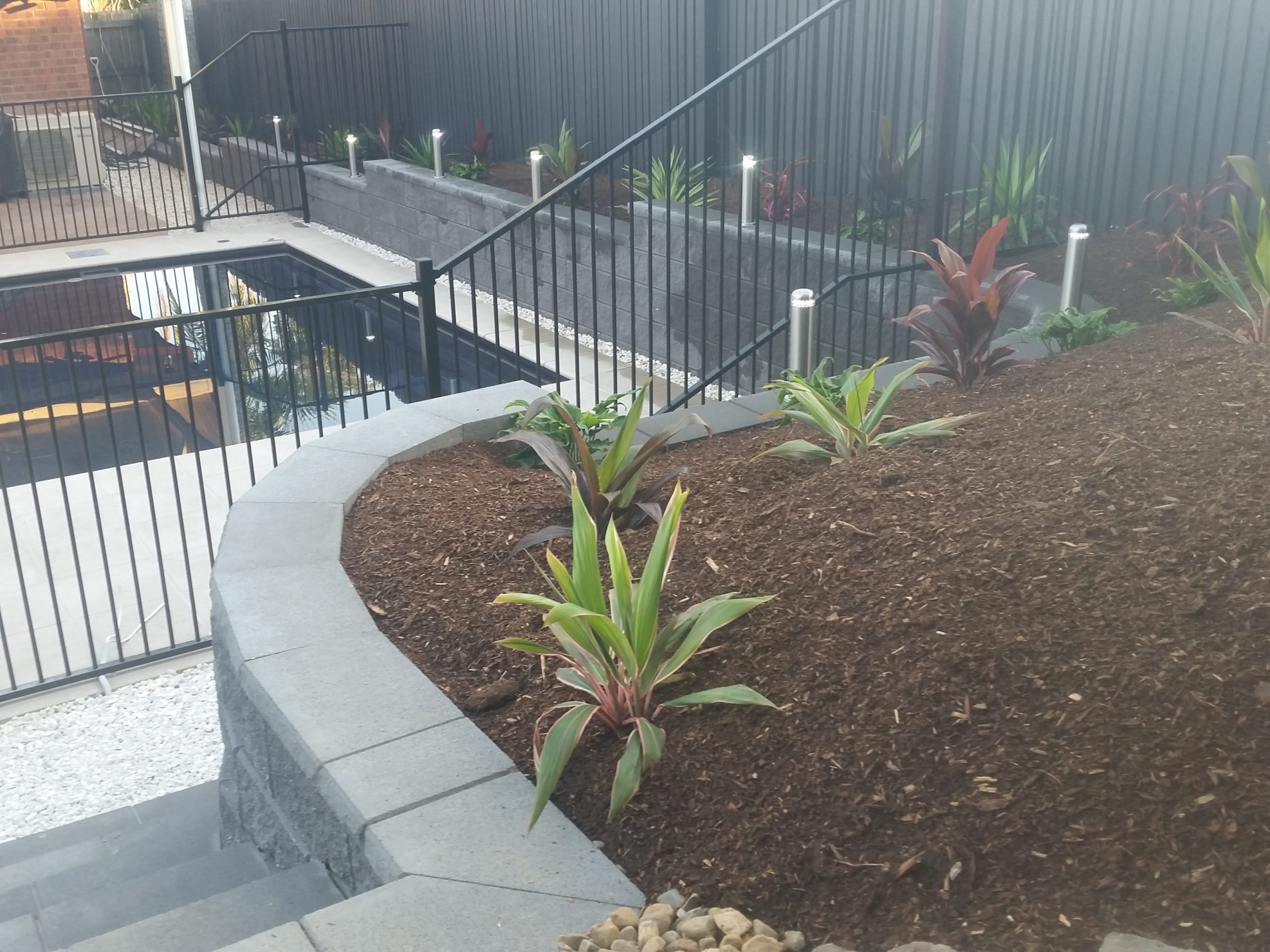 Retaining wall with in-built steps and a feature garden