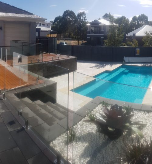 In-ground swimming pool and glass fencing